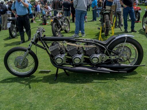 A custom black motorcycle with three Yamaha engines