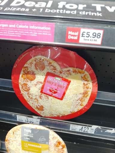 A photo of a heart-shaped supermarket pizza